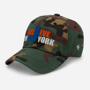 Right angel view of Believe in NYK camo trucker hat with orange and blue patches - Rebel P Customs